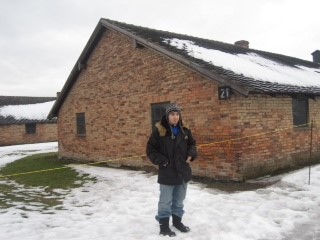 Daniel Kolender, Jeffrey's son and Pincus' grandson, in front of one of the Auschwitz barracks - 2010